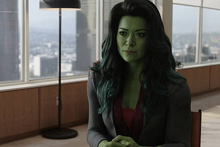 Hauptprotagonistin She-Hulk (groß und grün) sitzt in ihrem neuen Büro.